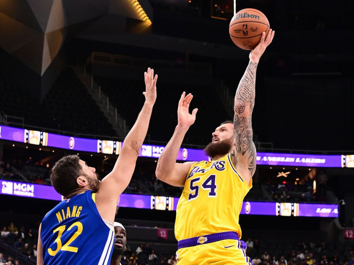 Lakers forward Sandro Mamukelashvili shoots over Golden State Warriors forward Georges Niang during an NBA preseason game in Las Vegas.